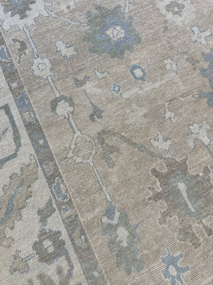 Frances Turkish Oushak rug styled in a room, neutral cream, blue, light green, brown, hand-knotted wool