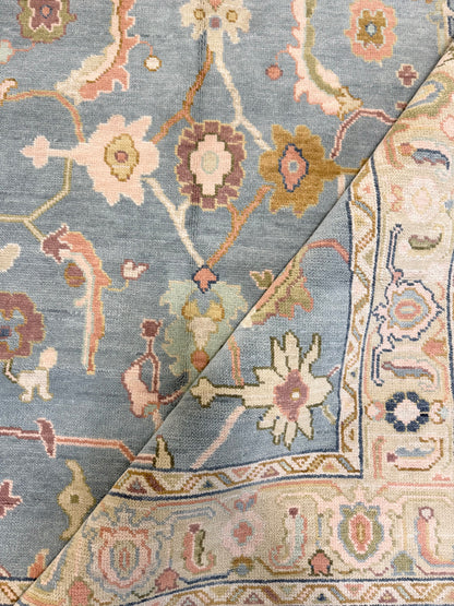 Madeline modern Oushak rug, hand-knotted wool with a blue foundation, sage border, and olive, navy, plum, pink, salmon, gold, and cream accents