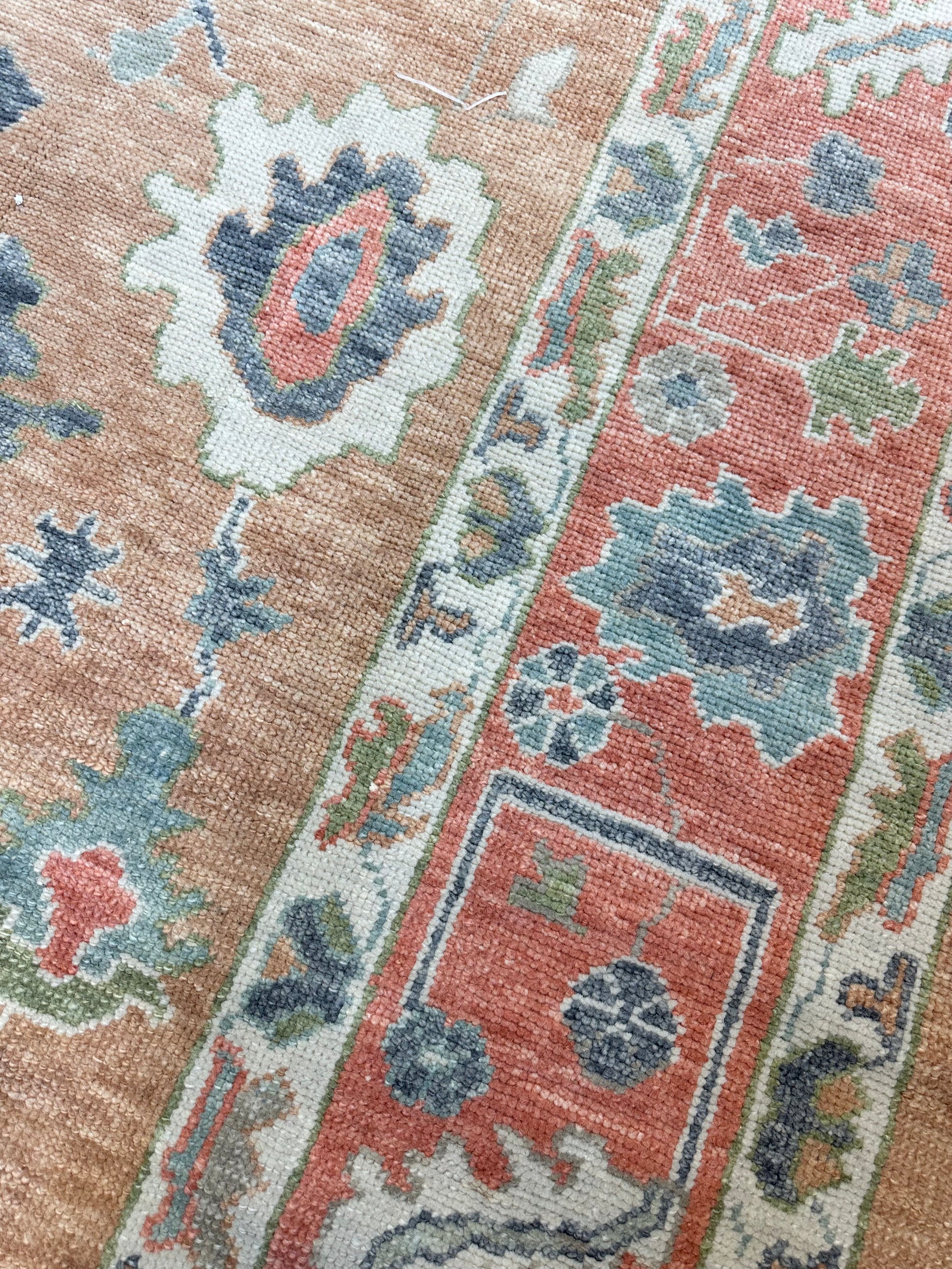 Beautiful hand-knotted wool Turkish modern oushak that is orange with accents of blue, green, navy, tomato red and cream.