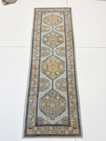Close-up of Gemma Turkish Oushak rug showing light aqua, turquoise, coral, brown, cream, green, hand-knotted wool