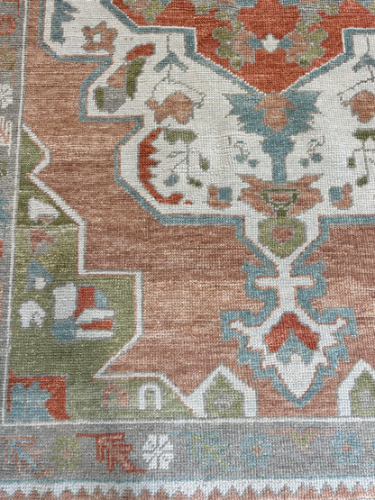 Chelsea Turkish Oushak rug styled in a room, coral-orange, rust, bright blue, apple green, ivory, warm gray, hand-knotted wool
