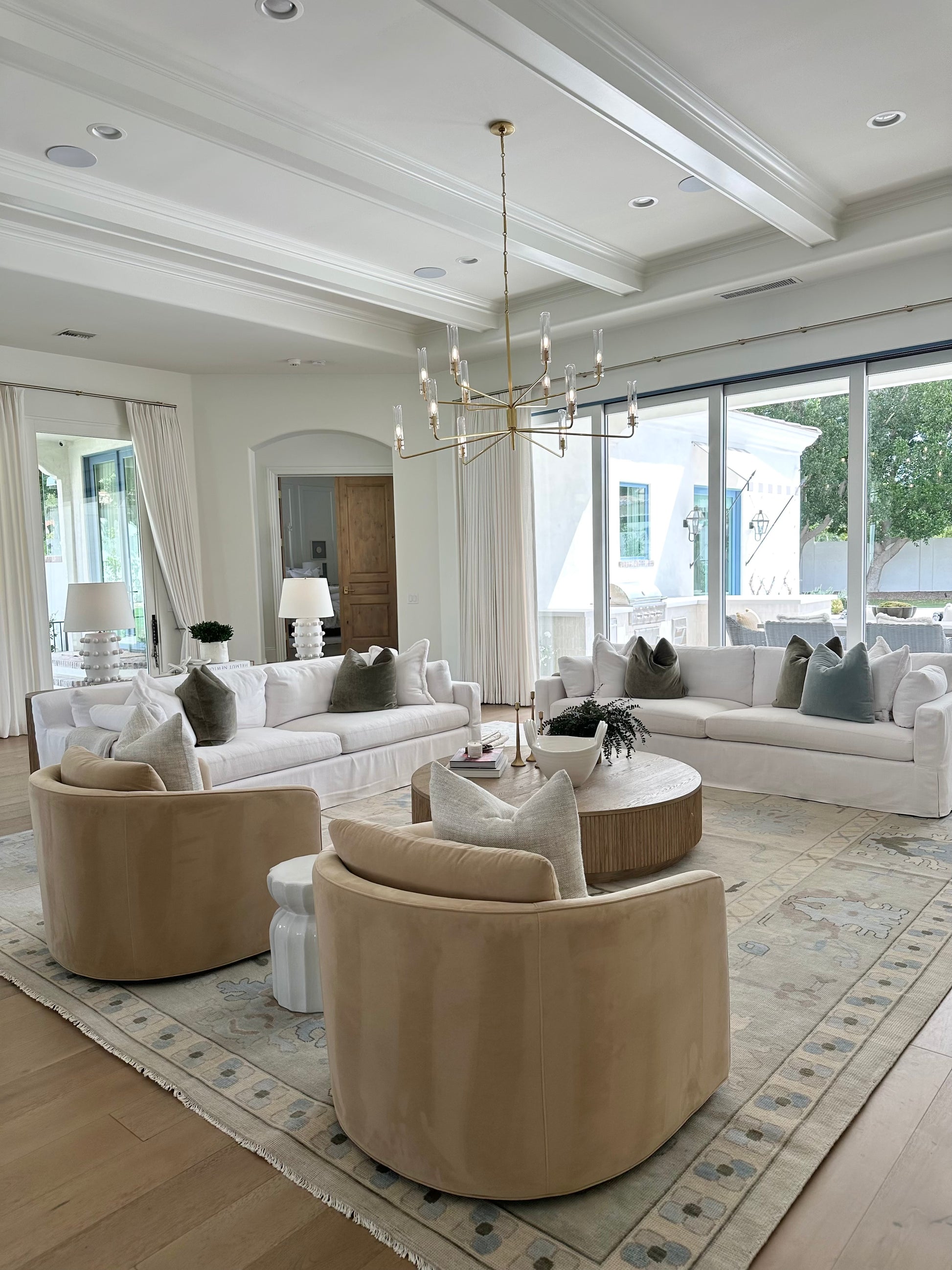 Evangeline Modern Oushak Rug Neutral with Blues and Greens in modern Living room with white sofas and camel colored chairs in Salt Lake City, UT