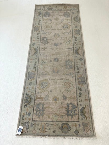 Evangeline Modern Oushak rug styled in a room, warm gray, sage, mossy green, soft blue, tan, hand-knotted wool
