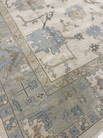 Close-up Evangeline Warm Oushak 100% rug wool with floral designs in beige, blue, green, and brown.