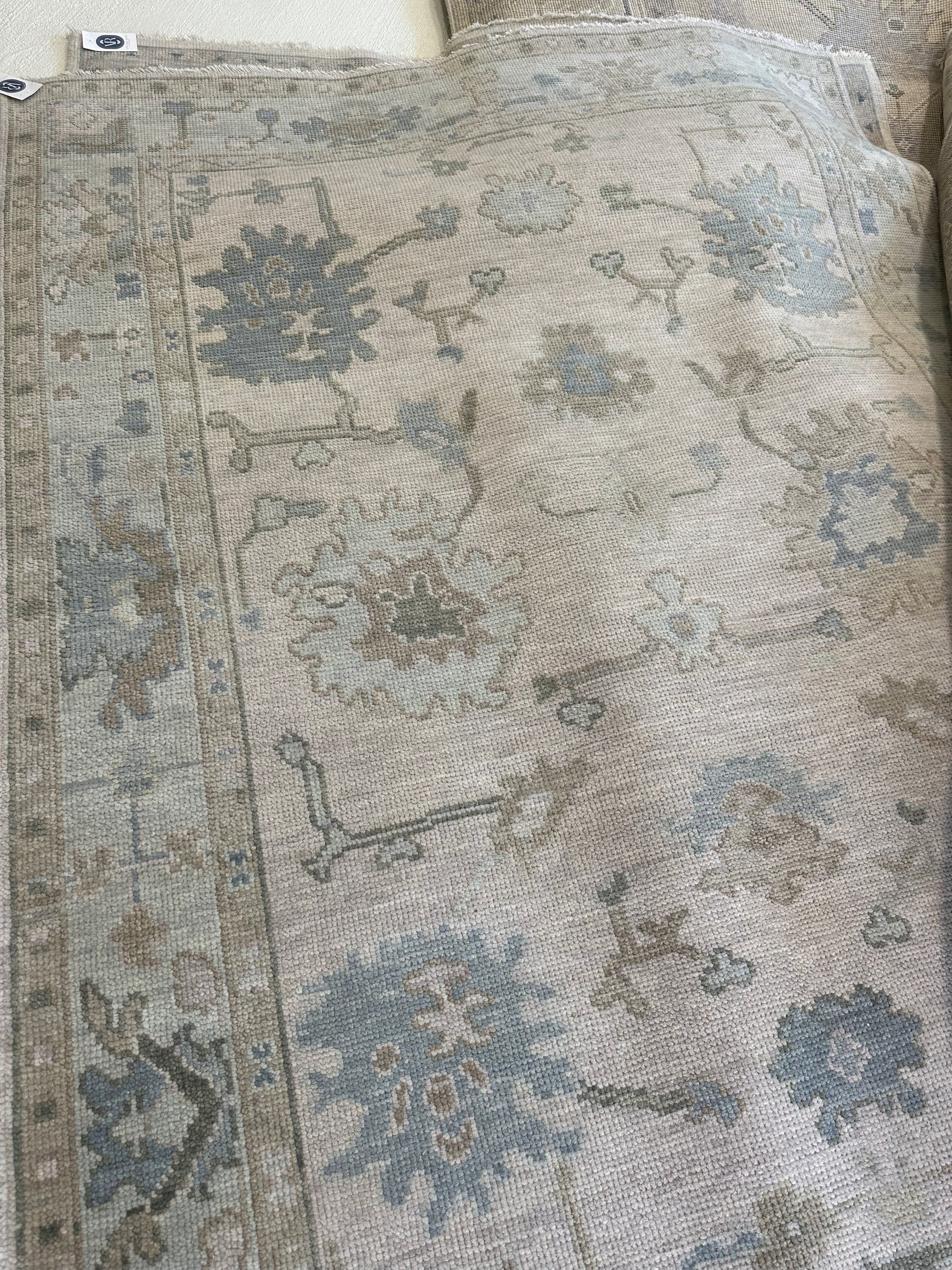 Bestselling Evangeline modern Oushak neutral rug with blues and greens Closeup 