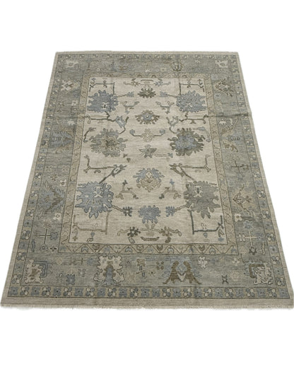 Neutral Modern hand knotted oushak rug with blues, greens, and browns and floral pattern