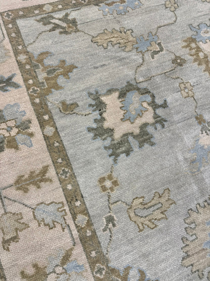 Lillian modern Oushak rug, hand-knotted wool with a muted sage green base, cream border, and dusty blue-green, taupe, and caramel accents