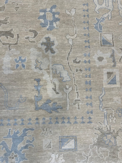 Close-up of Flora Turkish Oushak rug showing warm neutral, light blue, cream, hand-knotted wool