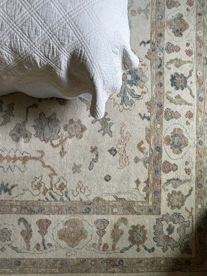 Felicity Turkish Oushak Rug Neutral color with blues greens and oranges in bedroom in Fairhope, AL