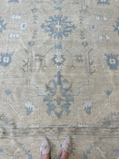 Neutral Turkish hand-knotted wool modern oushak with accents of brown, blue, and cream.