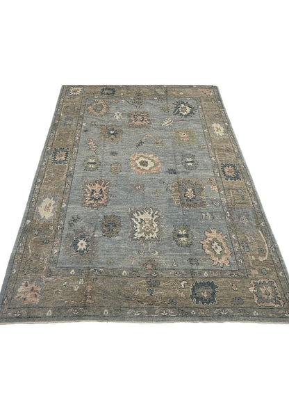 Juliet light blue Turkish Oushak rug with a tan border and pink, teal, and blue accents, hand-knotted wool