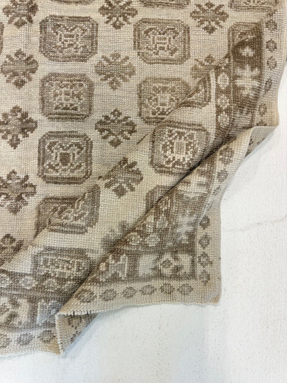 Kira hand-knotted wool Turkish Oushak rug with a geometric design in brown, gray, and tan