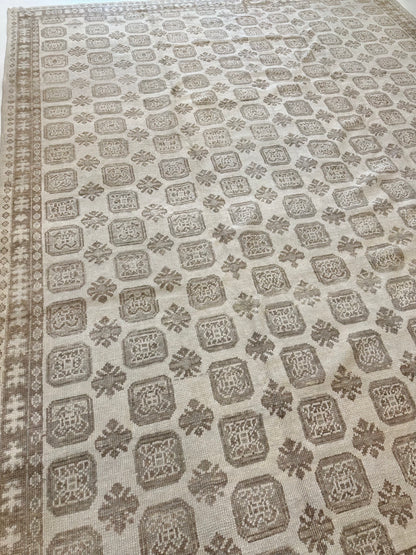 Kira Turkish Oushak rug, warm brown, soft gray, and natural tan in a geometric pattern