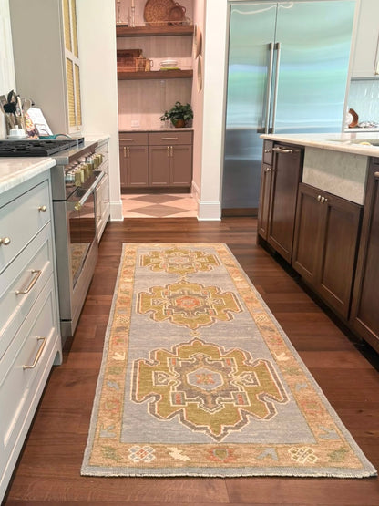 Veda Turkish Oushak rug — denim blue, warm brown, slate gray, moss green, rust, hand-knotted 100% wool
