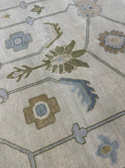 Close-up of Emmaline Modern Oushak rug showing beige, gray, cream, mossy green, blue, hand-knotted wool