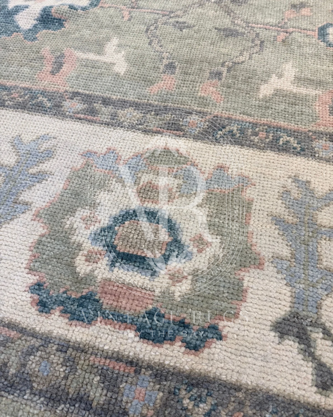 Gertrude Sage Green Turkish Oushak rug featuring a soft sage green base with accents of turquoise, salmon, cream, light blue, and gray in a timeless hand-knotted traditional pattern, perfect for living rooms, bedrooms, and elegant neutral interiors.
