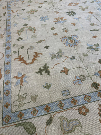 Ruth ivory and tan modern Oushak rug with soft blue, green, and bold rust orange, hand-knotted wool