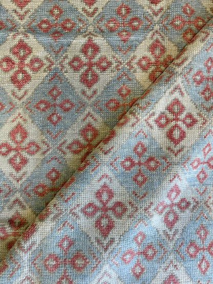 Martha Turkish Oushak rug with a diamond design in light blue, warm red, cream, and tan, hand-knotted wool