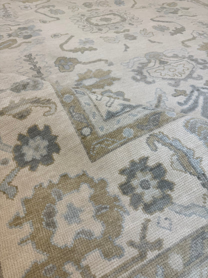 Kendal modern Oushak rug, hand-knotted wool with a cream background and light blue, warm tan, soft brown, and light green accents