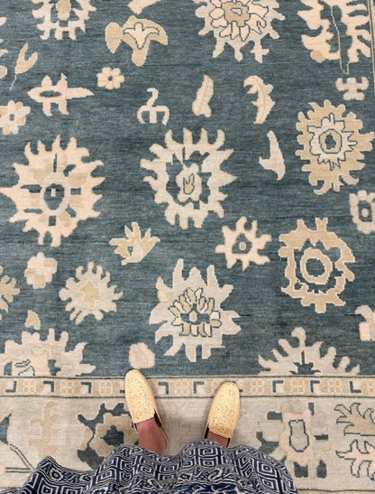 Lucille features a dark turquoise base, seafoam border, and cream and tan accents. Hand-knotted 100% wool oushak rug. In stock or made to order.