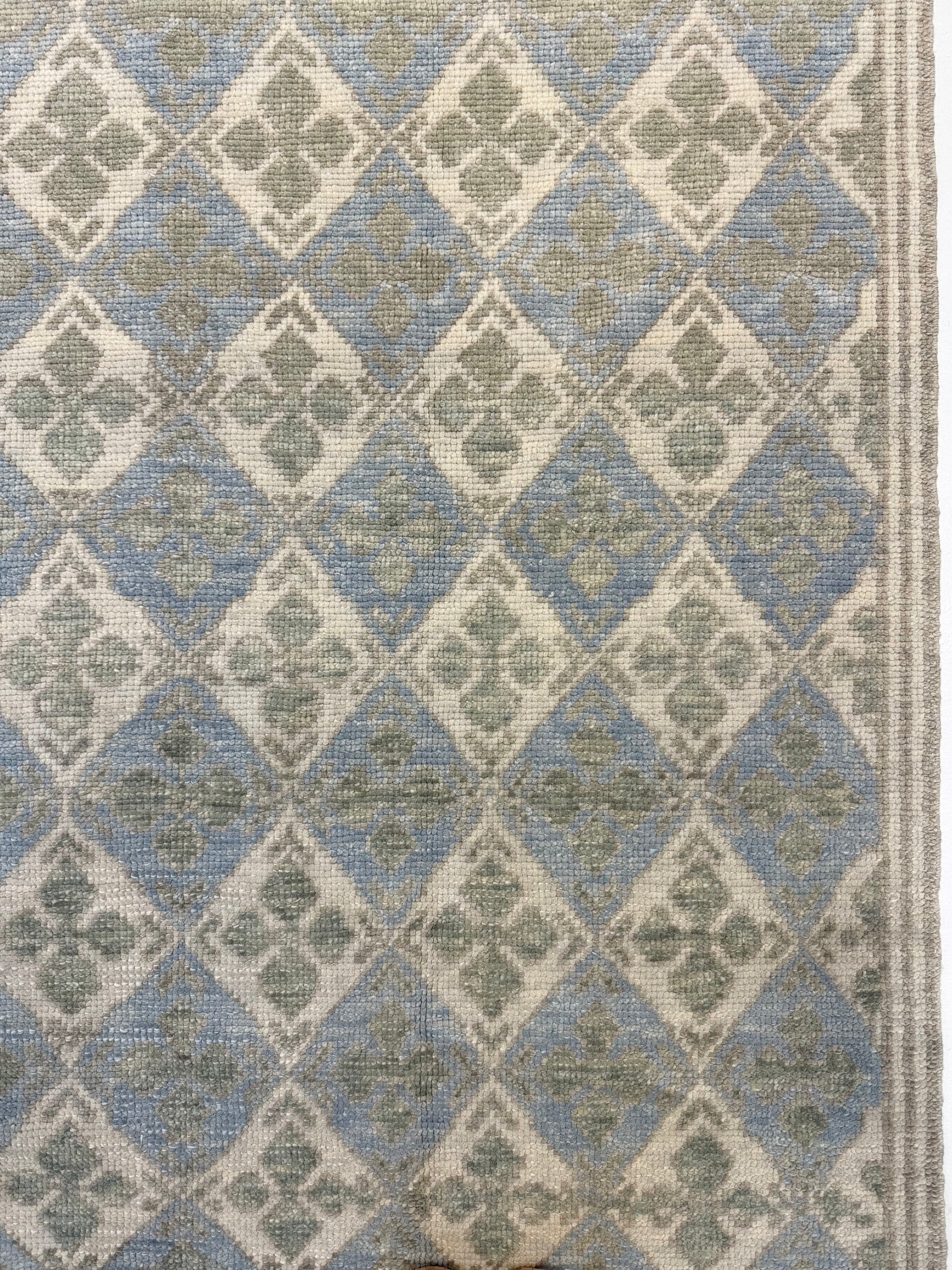 Turkish Oushak  rug with blue, green, and beige diamond design