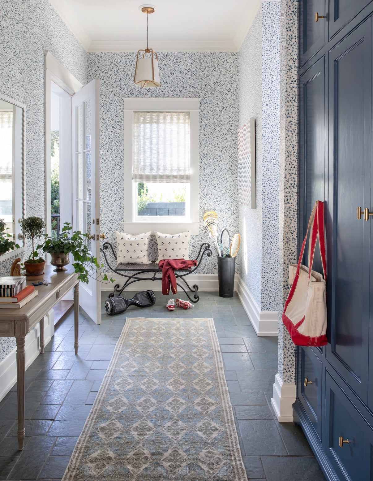Blue and green wool oushak runner in entryway with red accents
