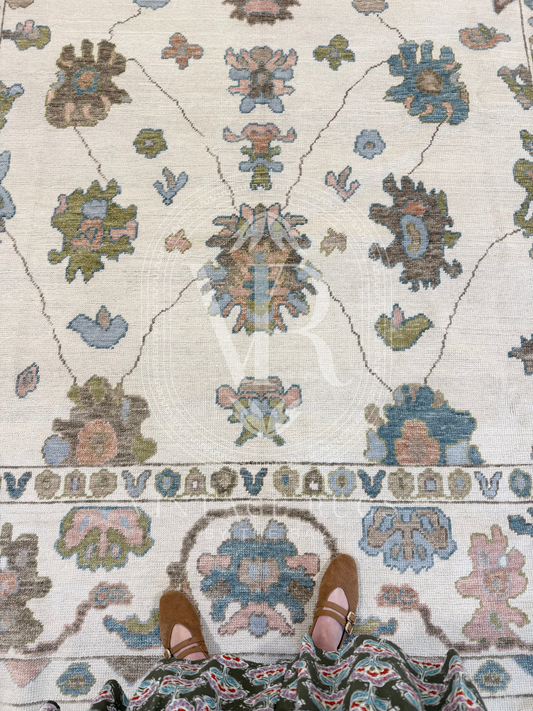 Hand-knotted Palmer Turkish Oushak rug with a soft neutral base and matching neutral border colorful accents featuring turquoise, salmon, chartreuse, light blue, and warm brown accents in a modern, colorful pattern—perfect for living rooms, bedrooms, nurseries, and dining spaces.