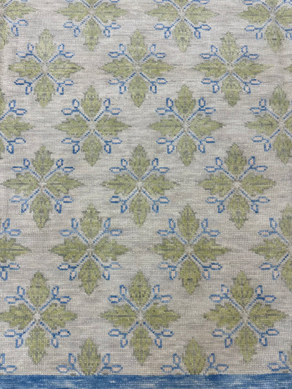 A hand-knotted wool modern Oushak area rug with a warm gray background and pops of color from cobalt blue, chartreuse, and light coral detail picture.