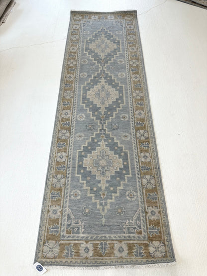 Blue modern oushak rug runner with accents of darker gray-blue, tan, cream, and brown border in kitchen that is In a home in Southern Living Magazine.