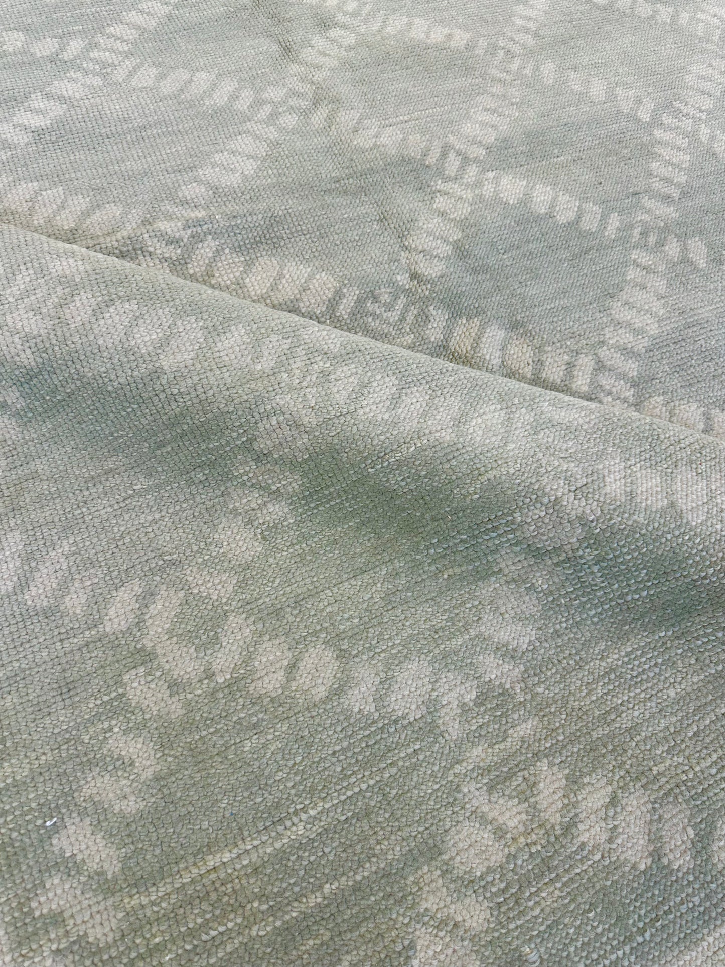 Close-up of Annie Turkish Oushak rug showing muted green, hand-knotted wool