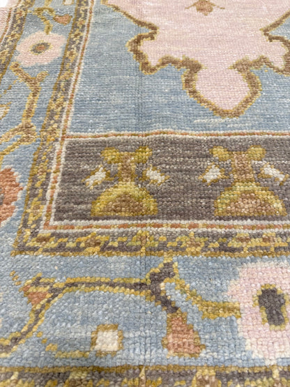 Close-up of Blaire Turkish Oushak rug showing lavender, light blue, brown, pink, chartreuse, orange, hand-knotted wool