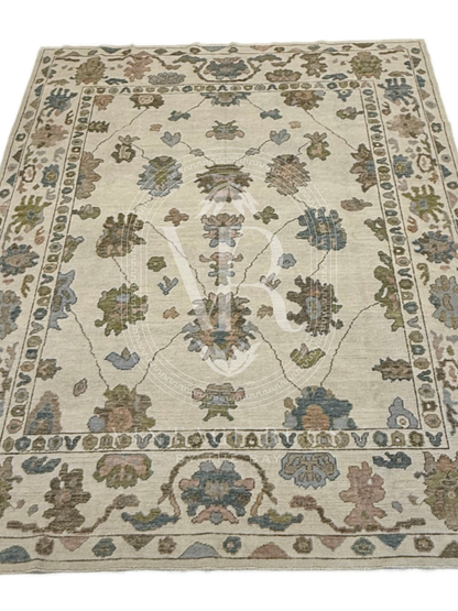 full view of Hand-knotted Palmer Turkish Oushak rug with a soft neutral base and matching neutral border colorful accents featuring turquoise, salmon, chartreuse, light blue, and warm brown accents in a modern, colorful pattern—perfect for living rooms, bedrooms, nurseries, and dining spaces.