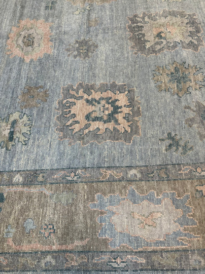 Juliet Turkish Oushak rug, hand-knotted wool with a light blue foundation, tan border, and pink, teal, and blue accents