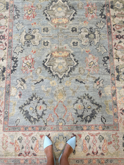 Kennedy Turkish Oushak rug, hand-knotted wool with a light blue base, ivory border, and navy, light gold, light green, and raspberry accents