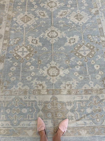 Dorothy Turkish Oushak rug styled in a room, gray-blue, cream, warm tan, light brown, hand-knotted wool