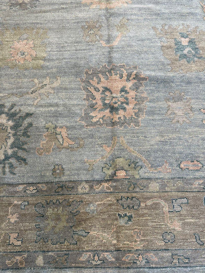 Juliet Turkish Oushak rug, hand-knotted wool with a light blue foundation, tan border, and pink, teal, and blue accents