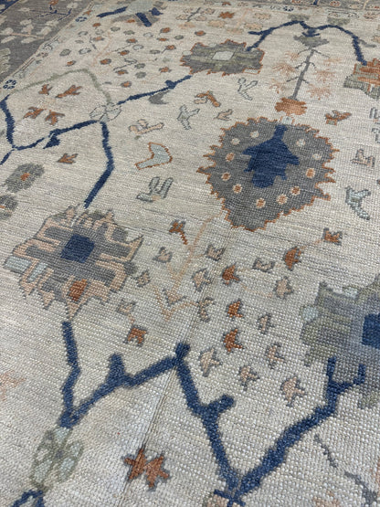 Sophia Turkish Oushak rug, ivory with gray border and orange, cobalt, light green, light blue, and tan accents