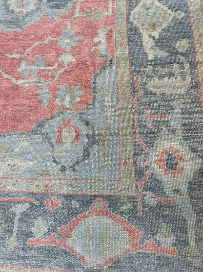 Ruby hand-knotted wool Turkish Oushak rug, raspberry red foundation with navy, light blue, and cream