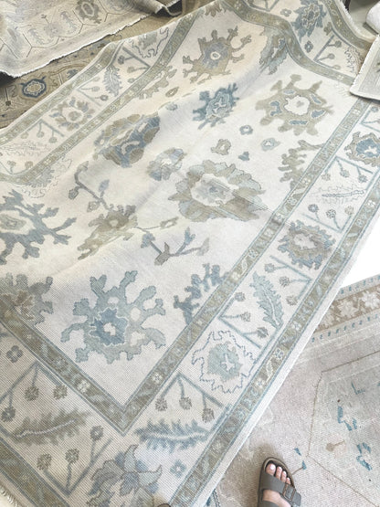 Close-up of Emily Modern Oushak rug showing cream, soft gray, blue, gray-green, warm tan, hand-knotted wool