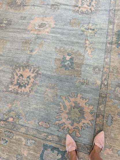 Juliet Turkish Oushak rug, hand-knotted wool with a light blue foundation, tan border, and pink, teal, and blue accents