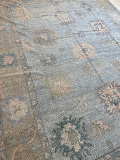 Juliet light blue Turkish Oushak rug with a tan border and pink, teal, and blue accents, hand-knotted wool