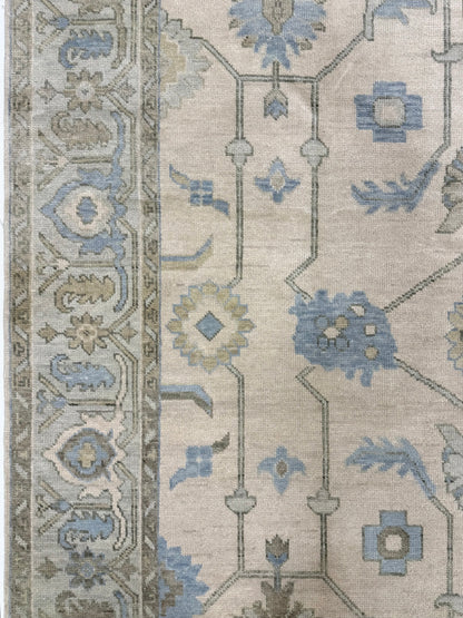 side of Laurel modern Oushak rug featuring a cream base with a soft seafoam border and accents of green, tan, and dusty blue, hand-knotted wool rug by Vintage Rugs by the Bay.