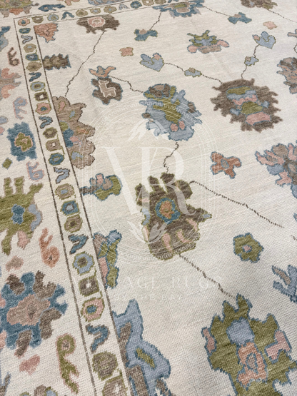 Side of hand-knotted Palmer Turkish Oushak rug with a soft neutral base and matching neutral border colorful accents featuring turquoise, salmon, chartreuse, light blue, and warm brown accents in a modern, colorful pattern—perfect for living rooms, bedrooms, nurseries, and dining spaces.