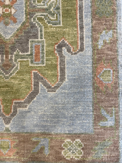 Close-up of a hand-knotted oushak runner rug with multicolor design including blue, green, orange, and brown