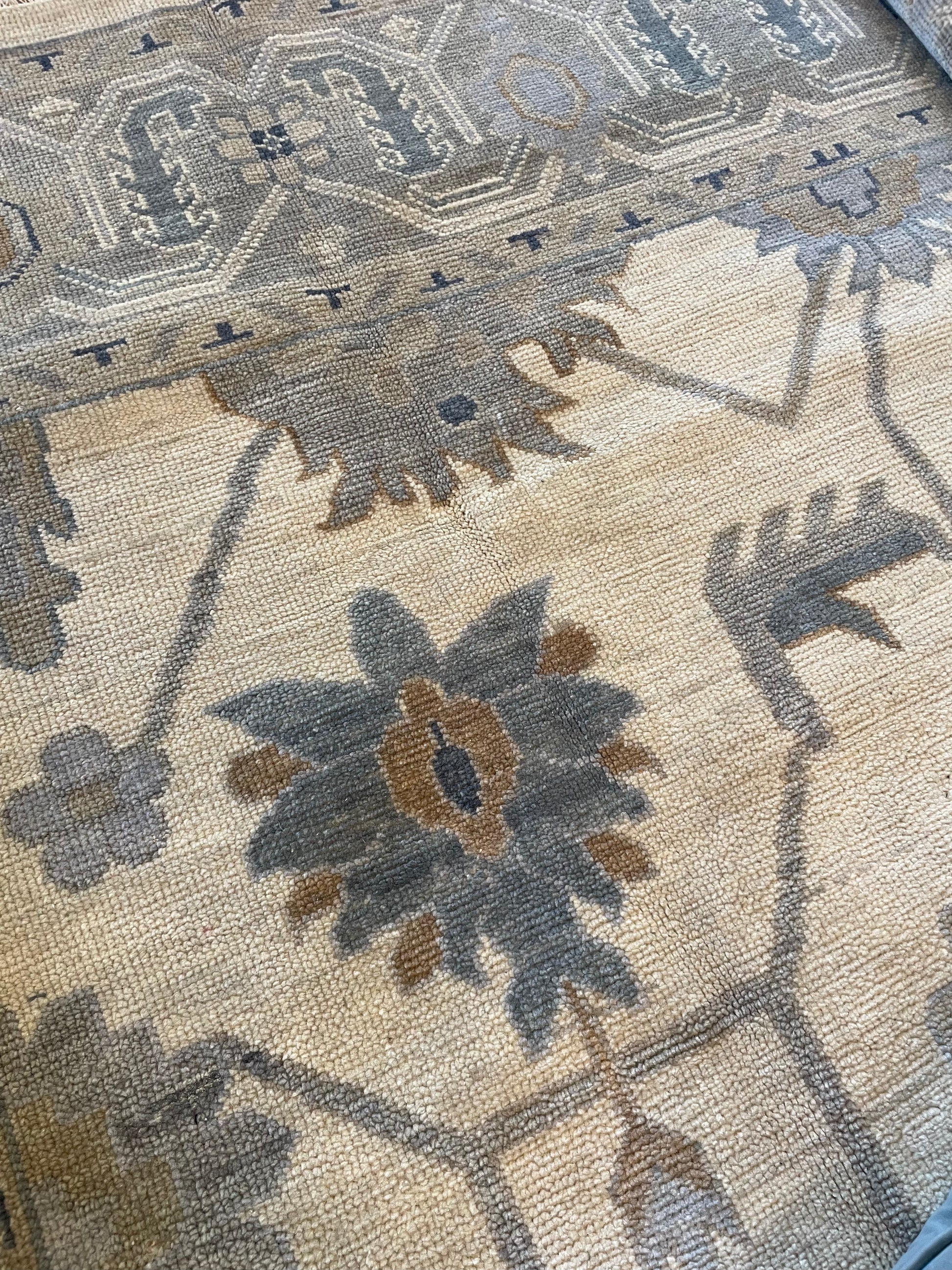 Emory Modern Oushak rug close up with blues, brown, and gray