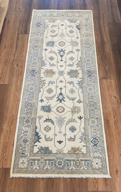 Close-up of Emory Modern Oushak rug showing soft cream, gray, tan, blue, hand-knotted wool