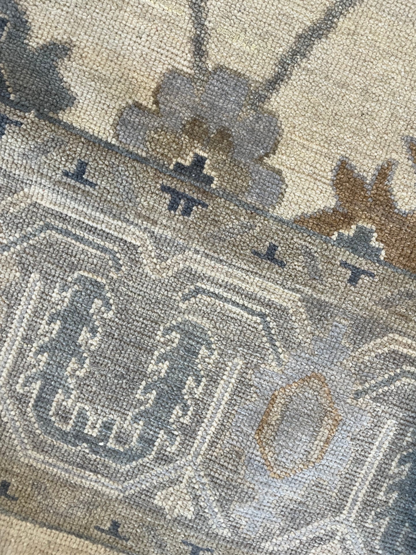 Modern Oushak Rug close up with blues browns and gold