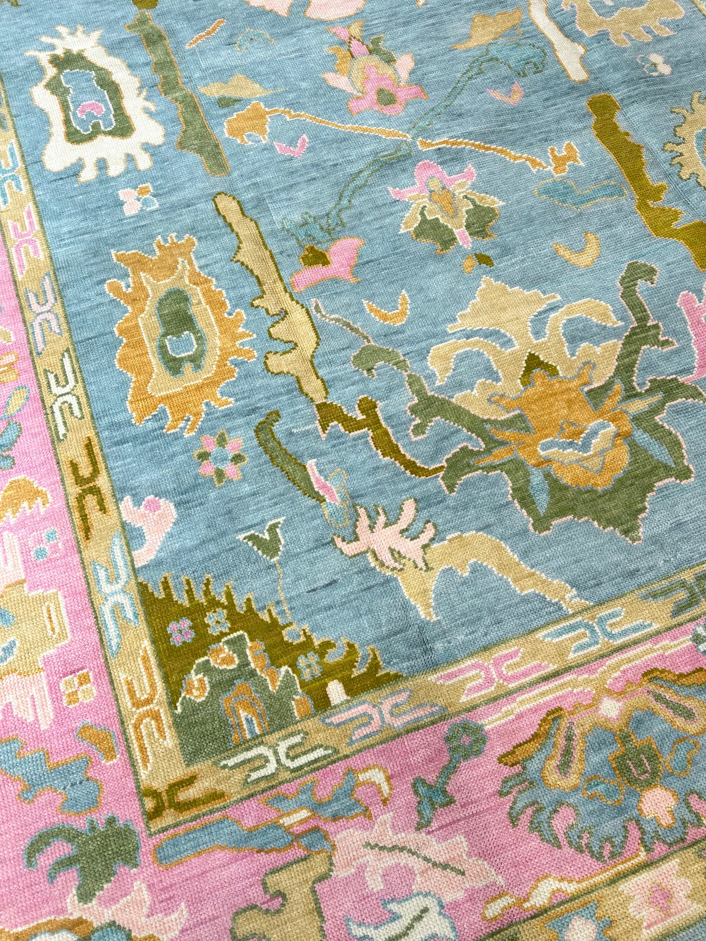 Addie Modern Oushak rug — medium blue, pink border, green, orange, tan, cream, chartreuse-olive, hand-knotted 100% wool
