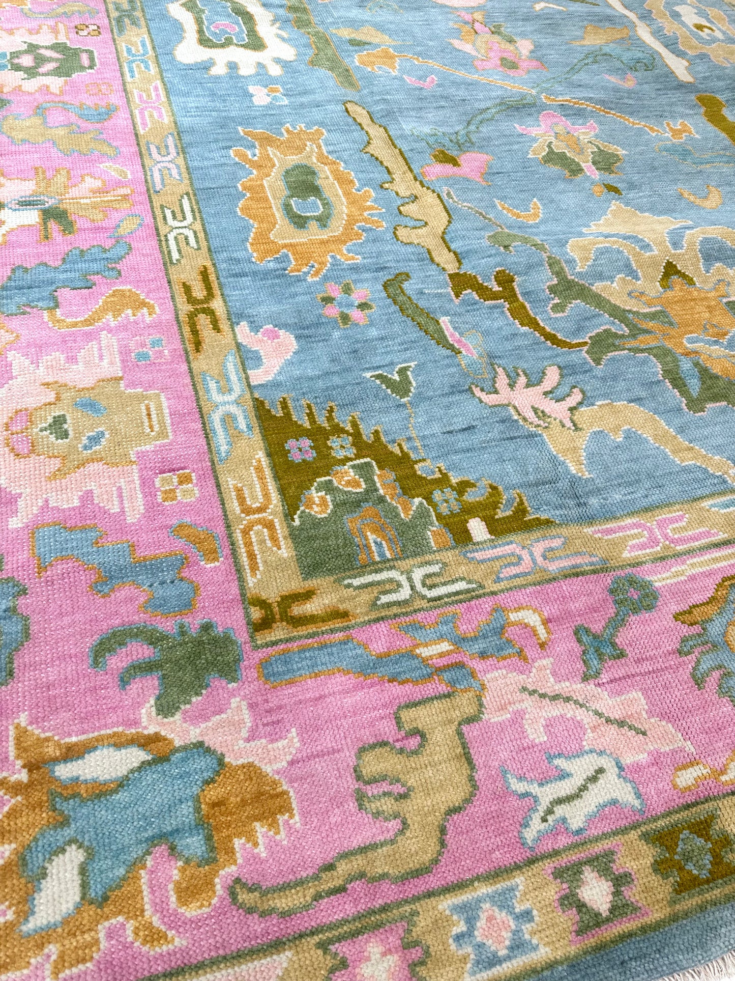 Addie Modern Oushak runner rug, medium blue, pink border, green, orange, tan, cream, chartreuse-olive, hand-knotted wool