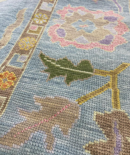 Close-up of Gracie Modern Oushak rug showing blue-green, orange, pink, purple, green, tans, hand-knotted wool (view 13)